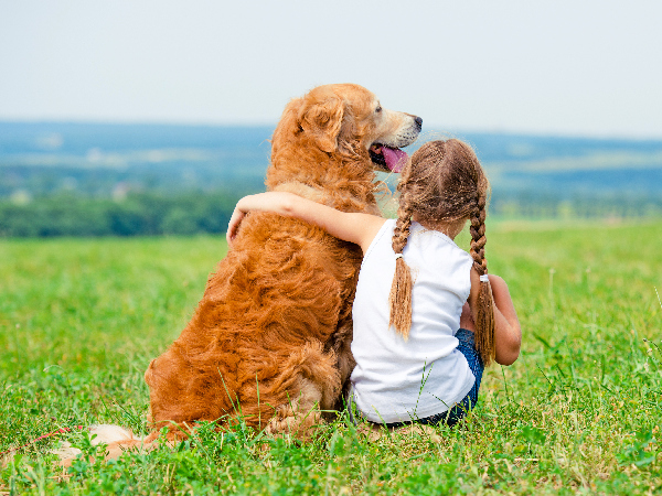 dog and child hugging