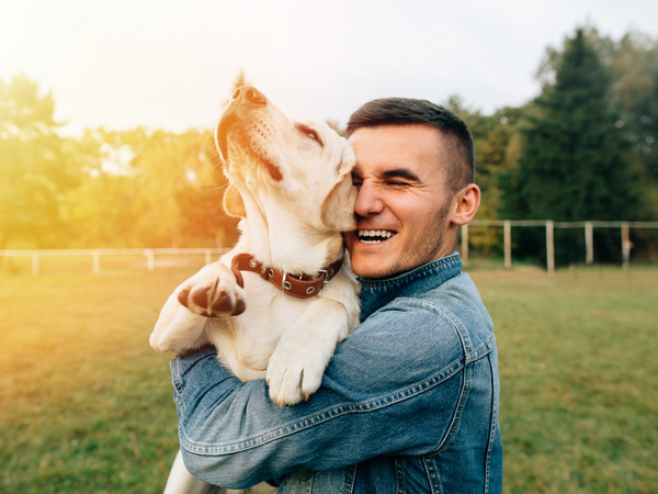Image of a happy dog owner for article on the benefits of having a dog