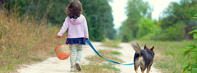 Image of a child and a dog for article on how to help children cope with losing a pet