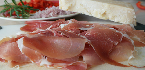 slices of parma ham beside cheese