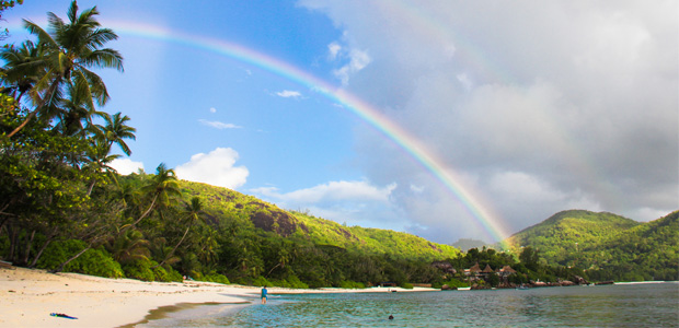 rainbow stretching above palm beach